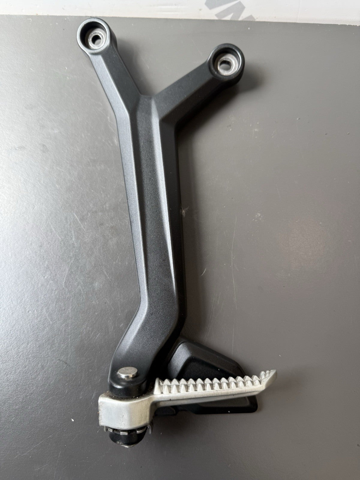 TRIUMPH TRIDENT 660 Left Rear Footrest Hanger - T2086605 2021-2024 Left Footrest