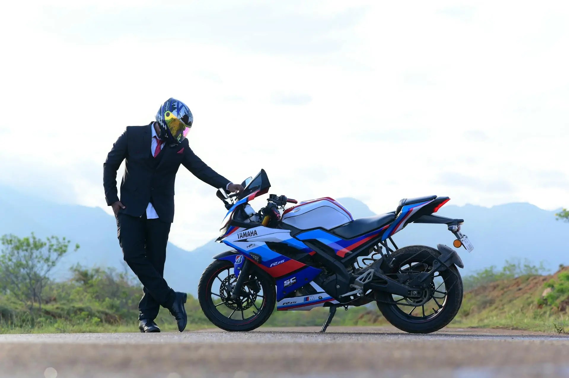 Man leaning on Yamaha motorbike