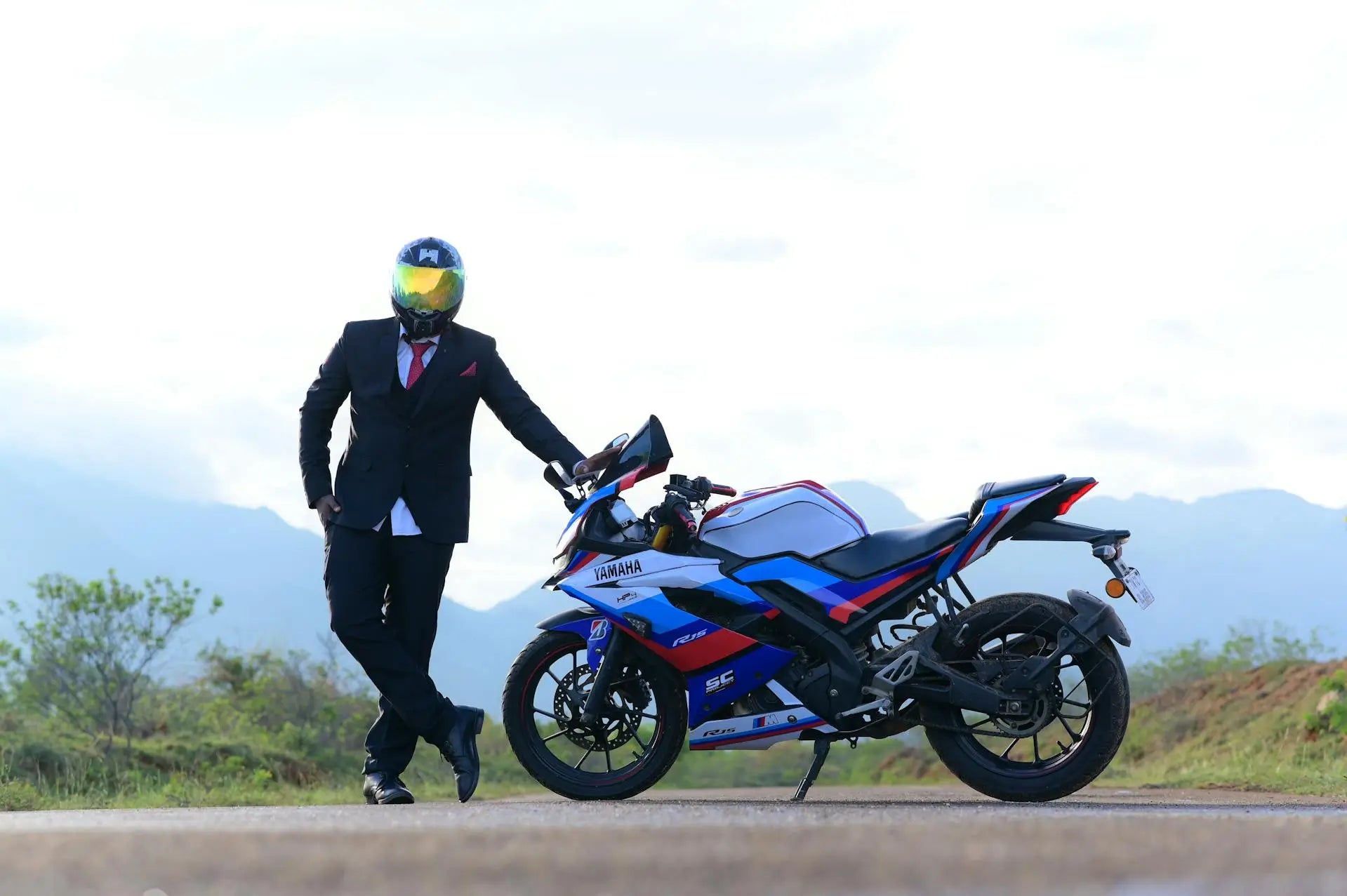 Yamaha motorbike and parts with man leaning